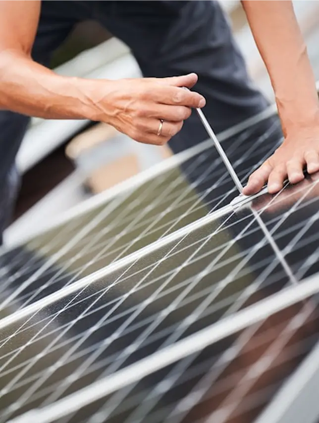 Solar installer working on a solar panel.